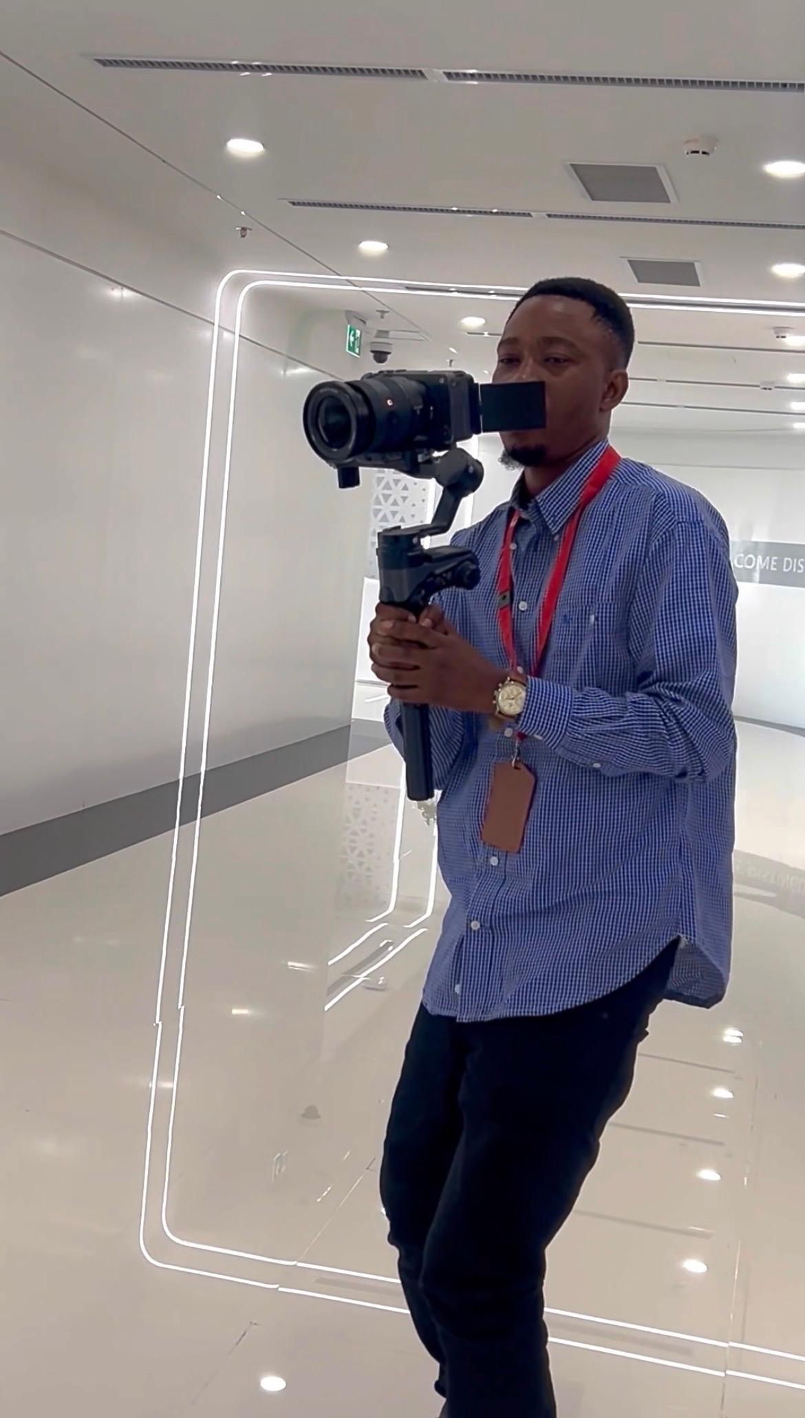 The filmmaker behind BJ Media Production concept at work, lit by a single window