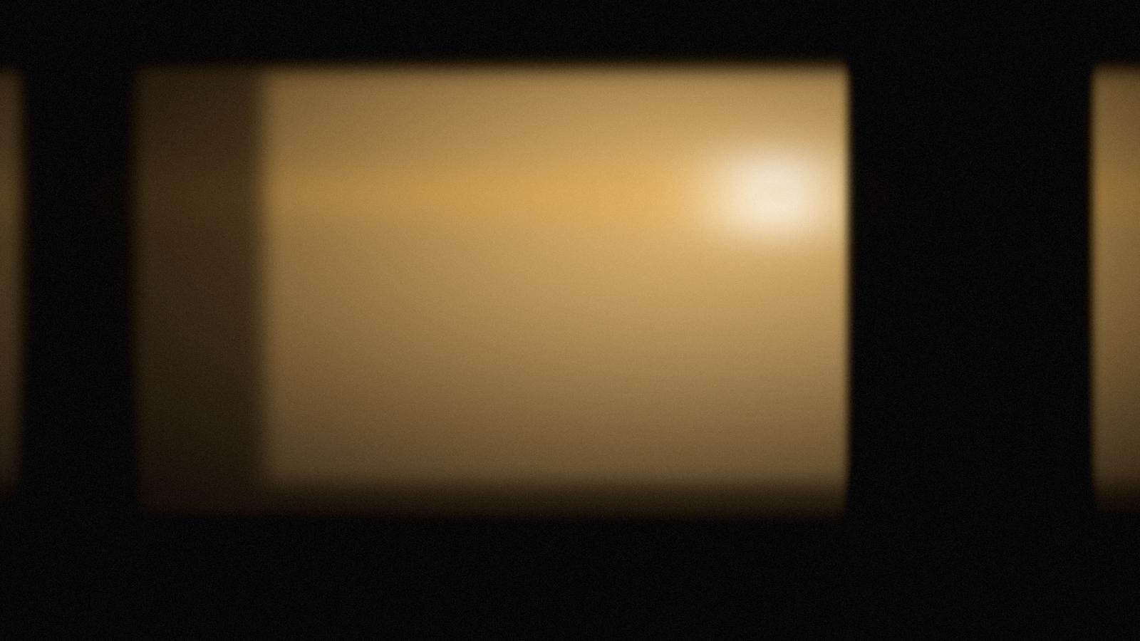 Warm amber stage light in a dark auditorium.