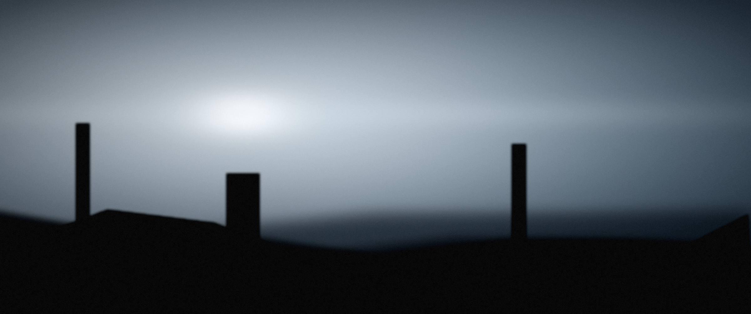 A wide coastal ridge under bright, cold storm light.
