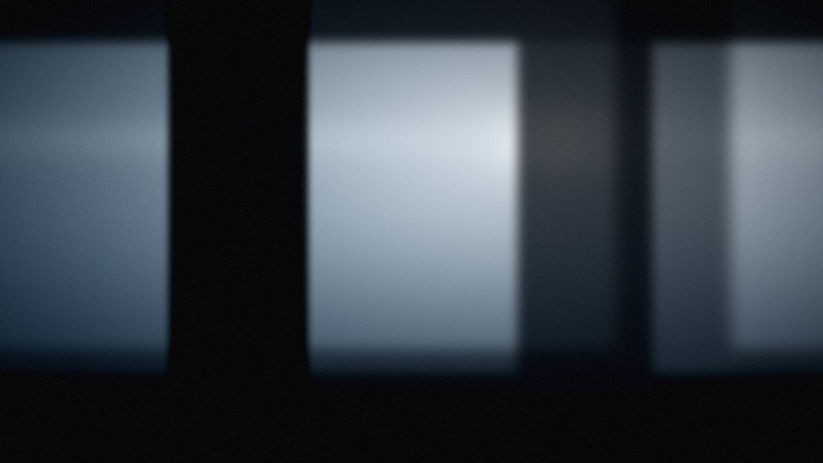 Cool daylight falling through tall factory windows.