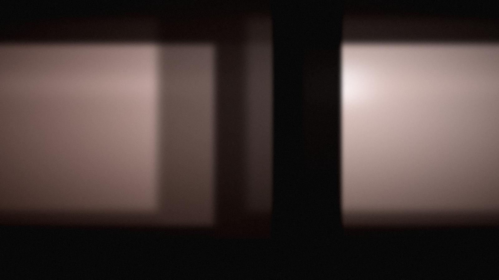 Soft blush light across a pale studio set.