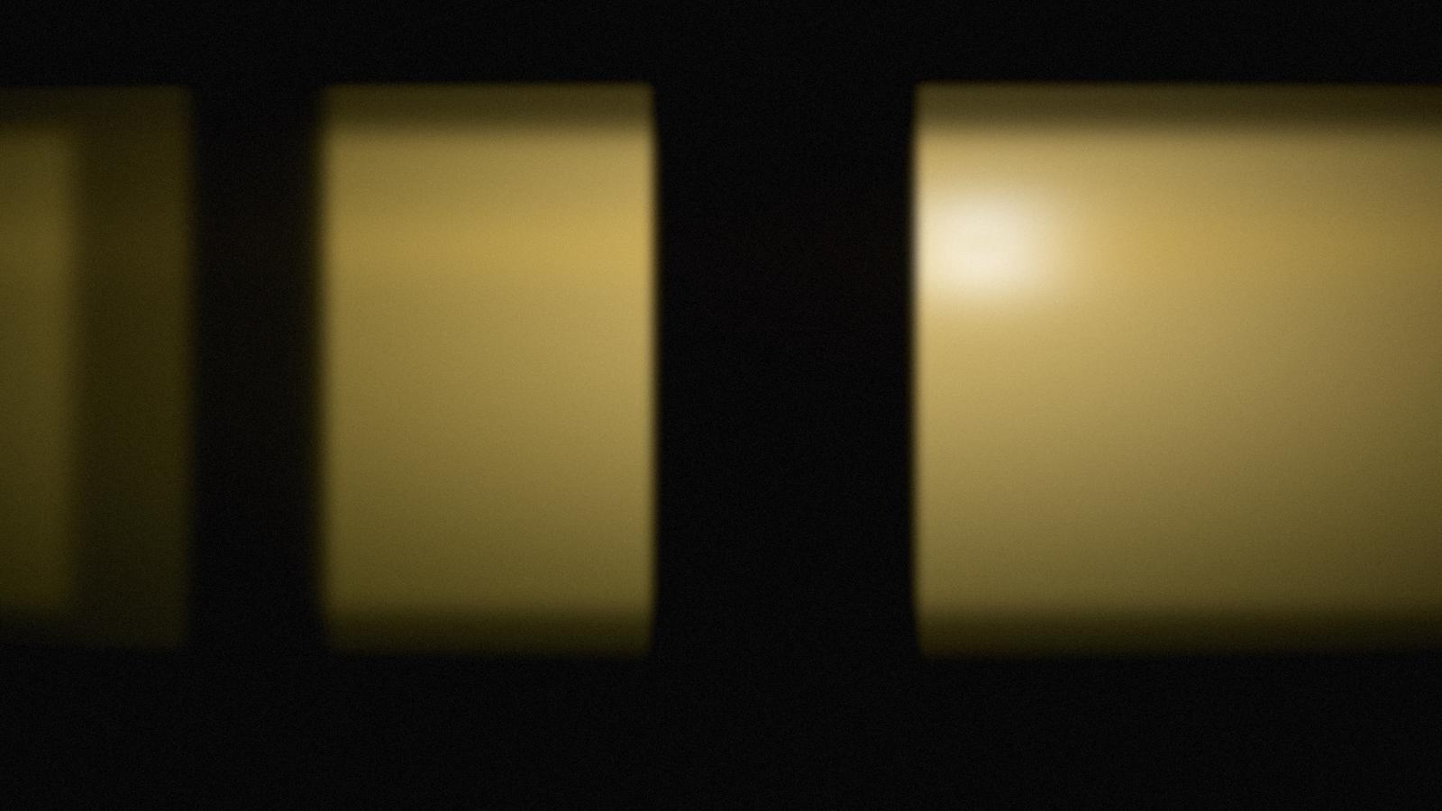Warm brass-toned light across a dark workshop bench.