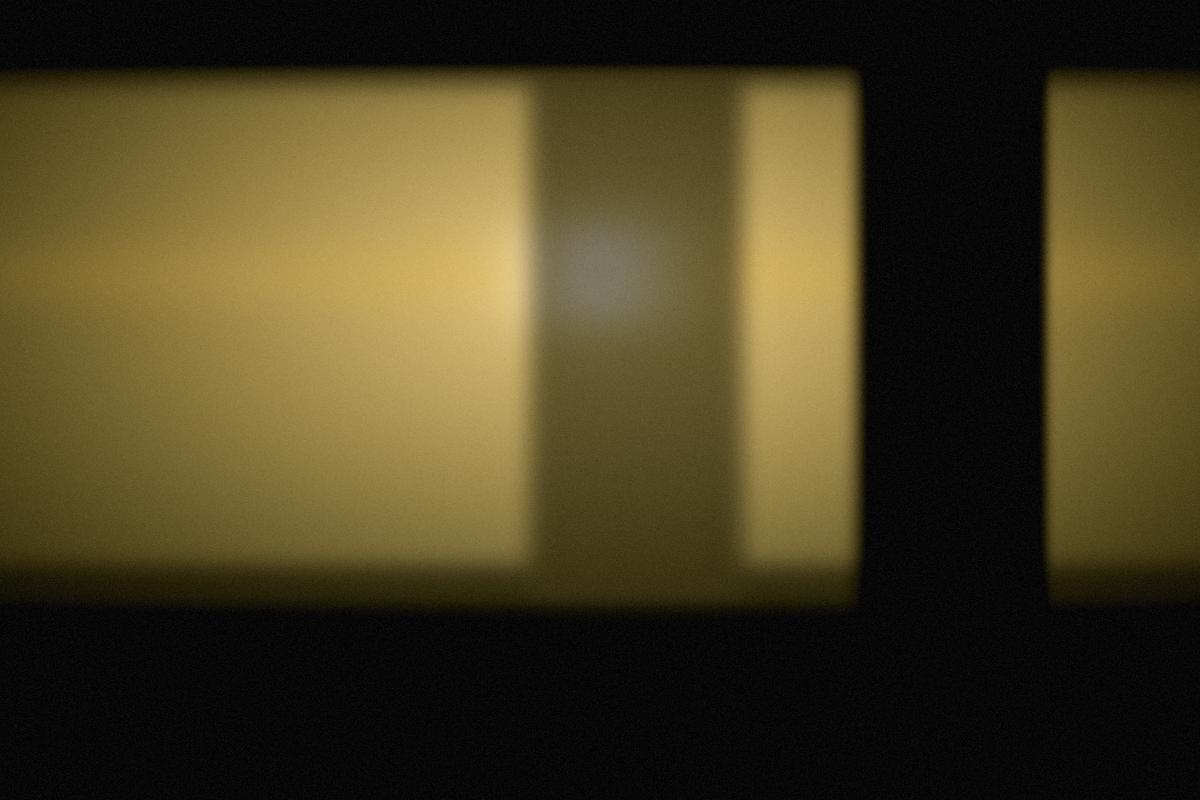 Torch light against a dark workshop wall.