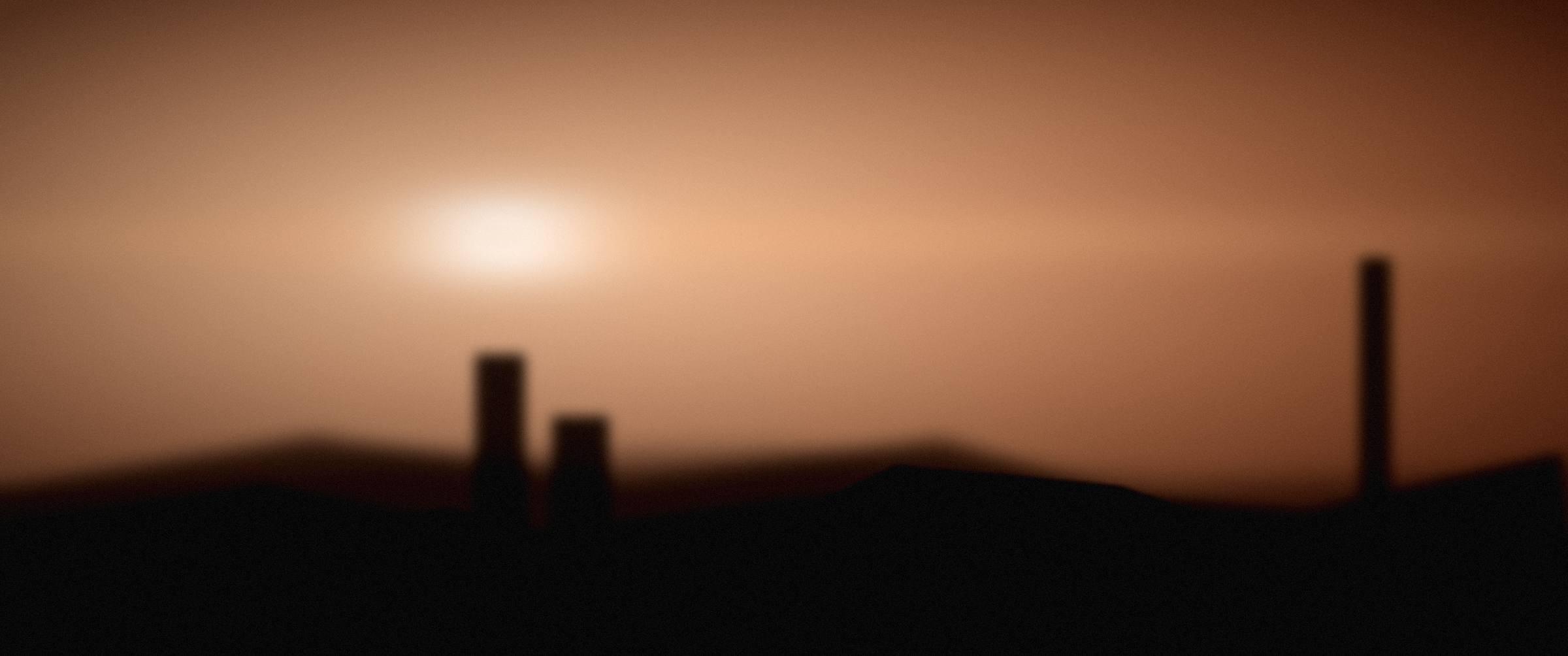 Warm evening light across a Lisbon hillside of rooftops.